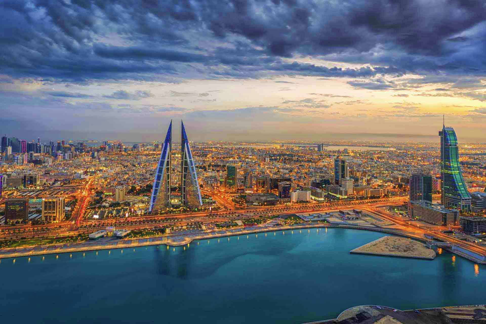 Bahrain Visa Bahrain skyline at sunset featuring the iconic Bahrain World Trade Center twin towers overlooking the Persian Gulf waterfront